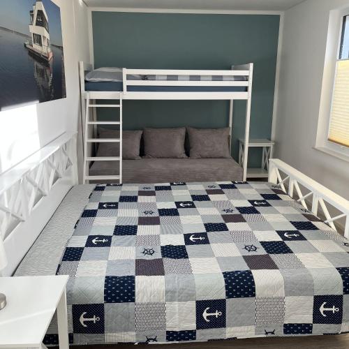 a bedroom with a bunk bed with a checkered blanket at Floating-Haus Meerferien in Bitterfeld