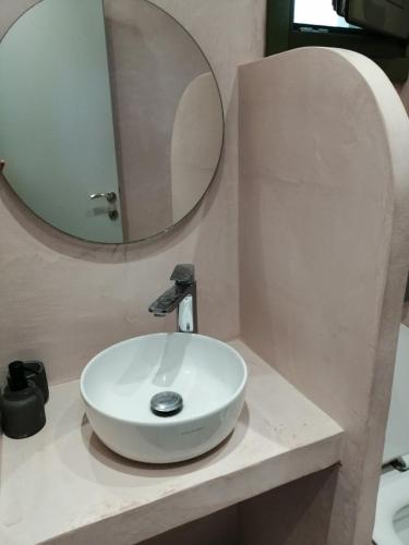 a bathroom with a white sink and a mirror at Palacio Verde in Asprovalta