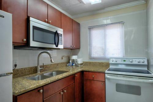 a kitchen with a sink and a microwave at Pet-Friendly And Really Close To Beach! in Bradenton Beach