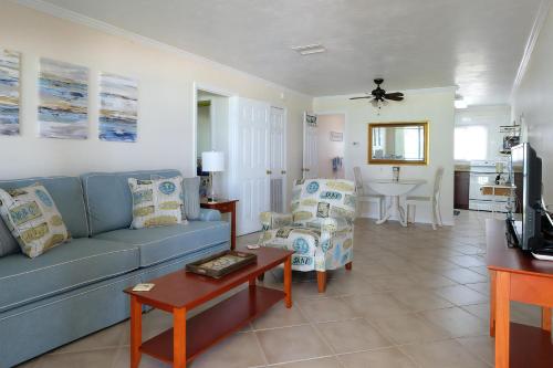 a living room with a blue couch and a table at Pet-Friendly And Really Close To Beach! in Bradenton Beach