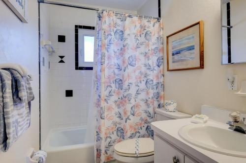 a bathroom with a shower curtain and a toilet and a sink at Pet-Friendly And Really Close To Beach! in Bradenton Beach
