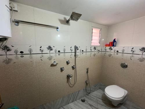 a bathroom with a shower and a toilet in it at Zen Luxe Abode in Siliguri