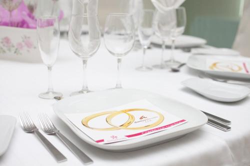 a table with a plate with two rings on it at Daniya Alicante in Alicante