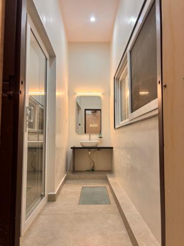 a bathroom with a sink and a mirror at Rajkamal Hampi in Hampi