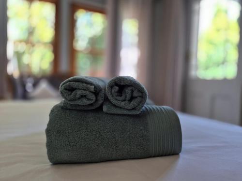 a stack of towels sitting on top of a table at 12 On Milner in Kimberley