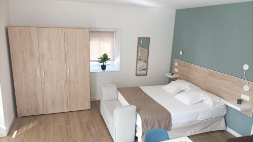 a bedroom with a large bed and a cabinet at Casa Senderos del Norte in Sauzal