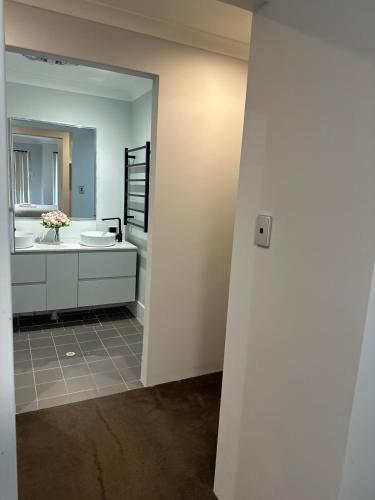 a bathroom with a sink and a mirror at Slate House Caversham in Caversham