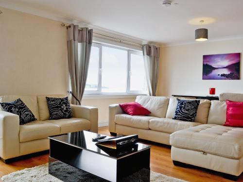 a living room with two couches and a coffee table at Seaview in Oban