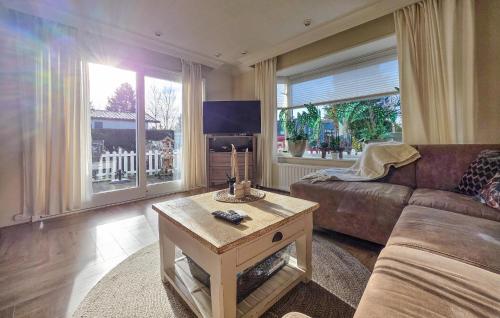 a living room with a couch and a coffee table at Nice Chalet In Putten in Putten