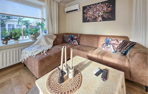 a living room with a brown couch and a table at Nice Chalet In Putten in Putten