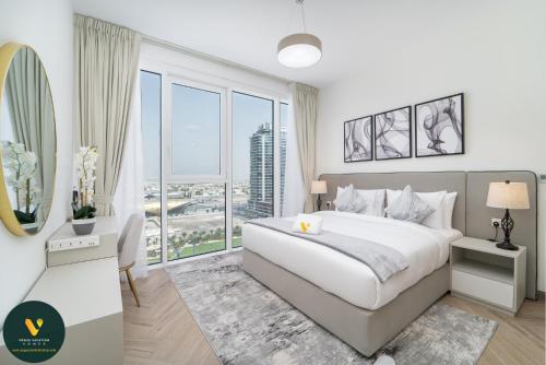 a bedroom with a large bed and a large window at Vogue Vacation Homes, Al Wasl 1 Residences Near Zabeel Park and World Trade Centre, Two Bedroom Apartment with Balcony and City View, Access to all Amenities, Walkable to Max Fashion Metro Station in Dubai
