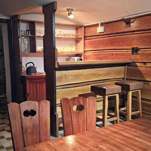 a kitchen with a table and chairs and a counter at Roubenka Vendryně in Vendryně