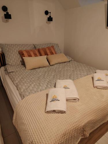 a bedroom with two beds with towels on them at Pienińskie Zacisze in Jaworki