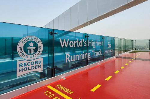 a building with the words worlds highest running track at Vogue Vacation Homes, Al Wasl 1 Residences Near Zabeel Park and World Trade Centre, Two Bedroom Apartment with Balcony and City View, Access to all Amenities, Walkable to Max Fashion Metro Station in Dubai