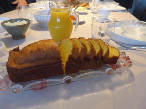 a loaf of bread on a table with orange juice at Maison de Luciné in Combourg
