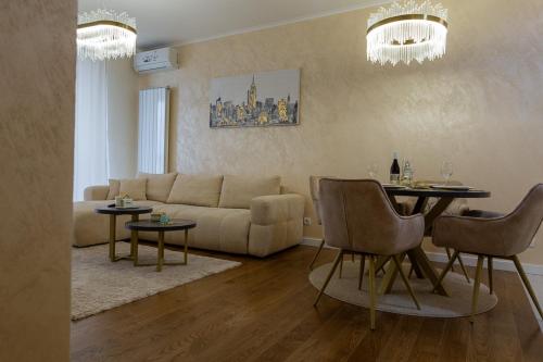 a living room with a couch and a table at Premium Planet Deluxe & SPA in Niš