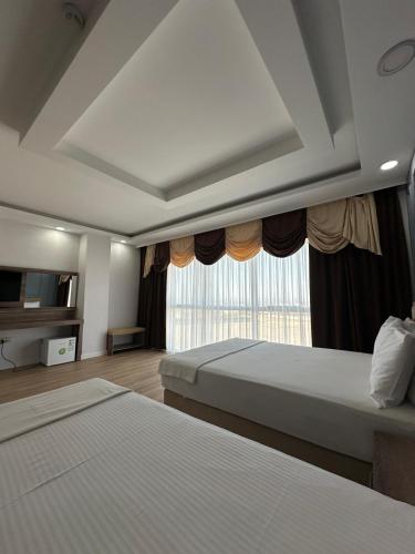 a hotel room with two beds and a window at İdil Haznedar Otel in İdil