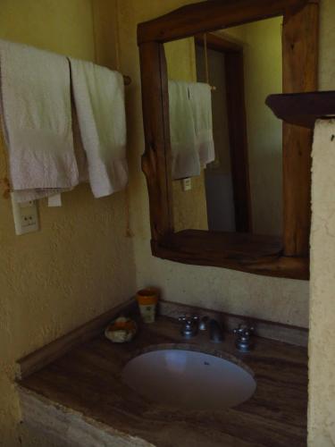 a bathroom with a sink and a mirror at Búho Multiespacio in Villa Giardino