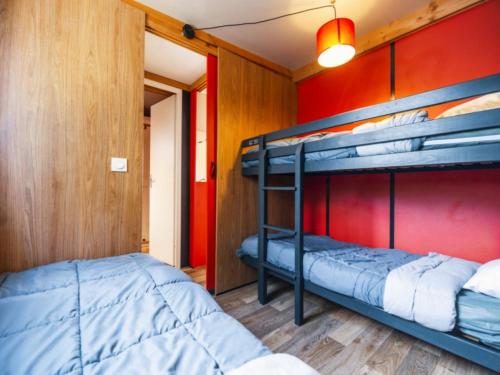 two bunk beds in a room with a red wall at Camping A la Corniche - Maeva in Angoulins-sur-Mer