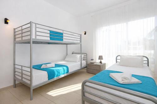 a bedroom with two beds and a bunk bed at Villa Katherine - Nissi Beach Area in Ayia Napa