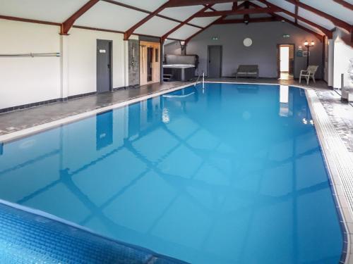 a large swimming pool with blue water at Berwyn Bank in Gilcrux