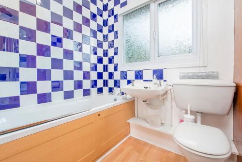 a bathroom with a toilet and a sink at Ty Peggie in Haverfordwest