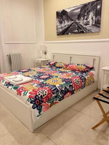 a bedroom with a bed with a colorful comforter at Milano Central in Milan