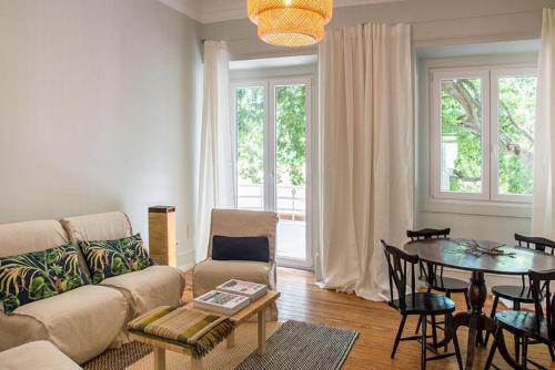 a living room with a couch and a table at Lisbon Evergreen Apartment in Lisbon