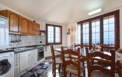 a kitchen with a table and chairs and a kitchen with a washing machine at Casa Mario in Torre Dei Corsari