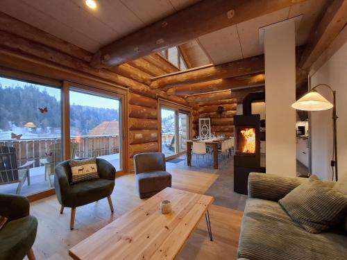 a living room with a couch and a table at Ferienblockhaus "Glashütte" mit Sauna, Todtmoos in Todtmoos
