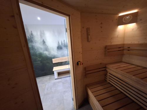 an empty cabin with a door open to a window at Ferienblockhaus "Glashütte" mit Sauna, Todtmoos in Todtmoos