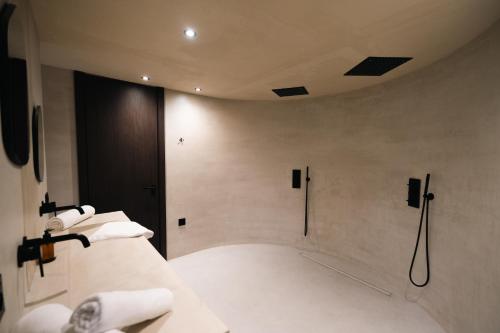 a bathroom with a shower with white towels at La Vague - Saint Tropez in Saint-Tropez