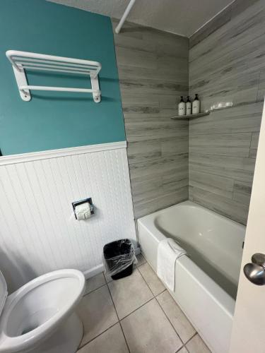 a bathroom with a toilet and a tub and a sink at Ocean Views - Heated Pool - Hot Tub - Corner Unit - steps to beach - SS 29 in Galveston