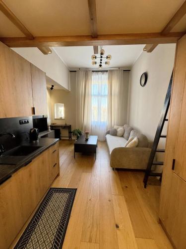 a kitchen and living room with a couch and a table at Justinrent 1 in Legnica
