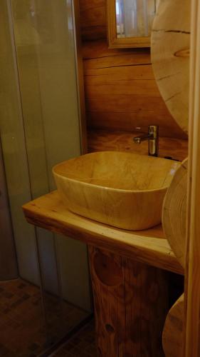 a wooden sink on a wooden counter in a bathroom at Rustic House in Predeal