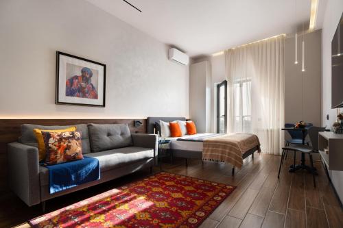a living room with a couch and a table at Blueloft 47 l studio with balcony Tashkent City Center in Tashkent