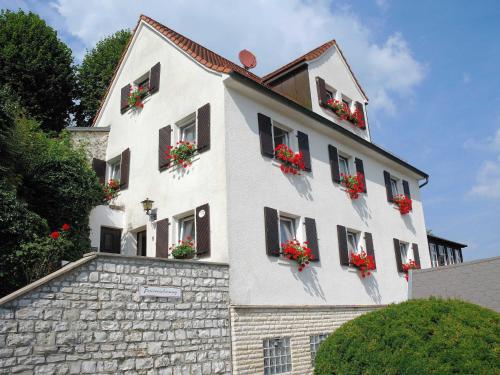 a white building with flower boxes on the windows at Ferienwohnung Haus Wagnershoehe in Gößweinstein