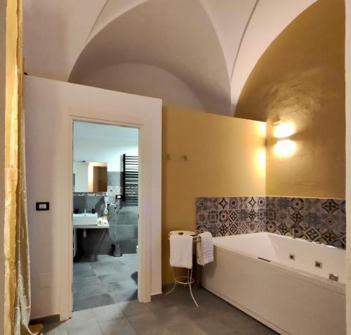 a bathroom with a bath tub and a sink at Aquarius Salento in Acquarica del Capo