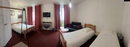 a small room with two beds and a couch at Agape Hotel Niort- Bessines in Bessines