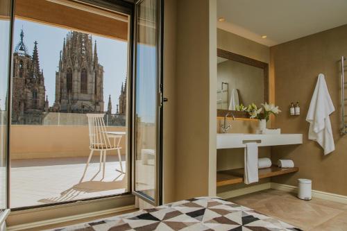 a bedroom with a bathroom with a view of a cathedral at Lamaro Hotel Barcelona - Preferred Hotels & Resorts - Lifestyle Collection in Barcelona