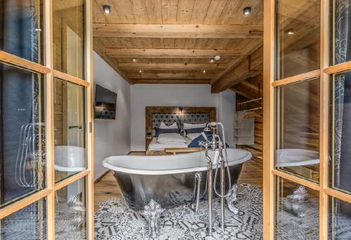 a bath tub in a room with a bed at Ascherhof in Thiersee
