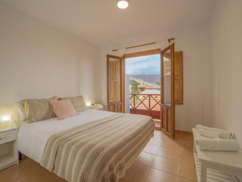a bedroom with a bed and a balcony at CHL La Mareta, cozy apartment with pool in Breña Baja