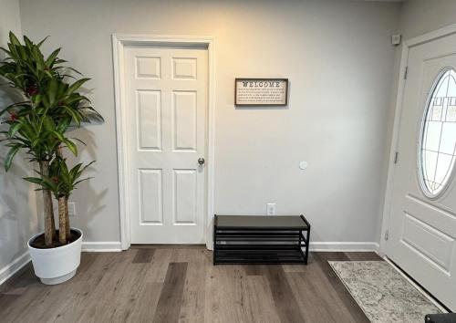 a hallway with a white door and a potted plant at Brand new spacious and comfort 3-bedroom villa in east central in Memphis