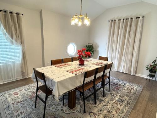 a dining room with a table and some chairs at Brand new spacious and comfort 3-bedroom villa in east central in Memphis