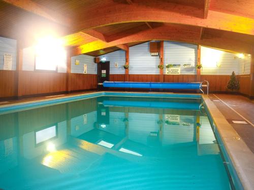 a large swimming pool in a building at Lodge 5 - Uk51086 in Lyme Regis