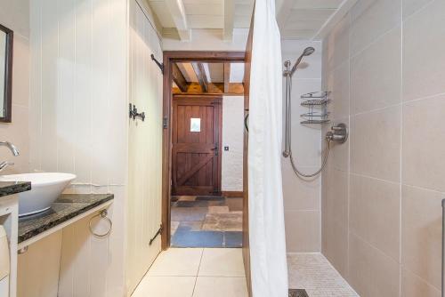 a bathroom with a shower and a sink at Coach House in Pembroke