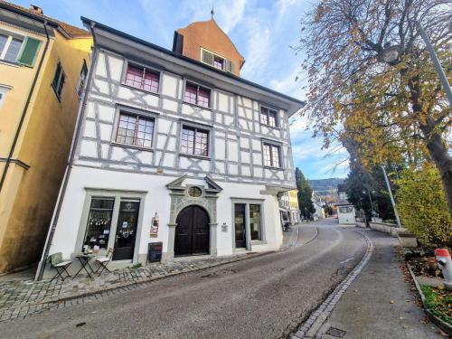 a white building on the side of a street at FEWOCASA Central Family Apartment Rorschach - Lake Constance - Near St Gallen in Rorschach