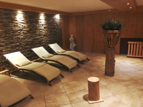 a row of chairs in a room with a brick wall at Ferienwohnung Kogelblick Gosau in Gosau