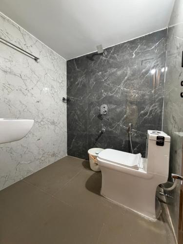a bathroom with a toilet and a sink at Suraksha Homestay in Malpe