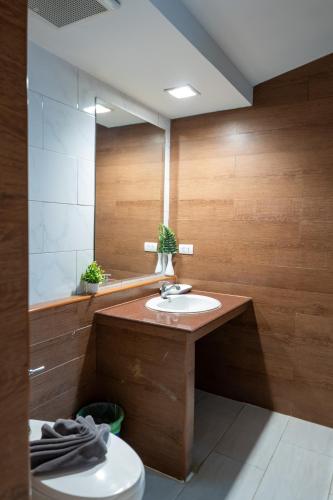a bathroom with a sink and a mirror at IP Plus Pool Villa Pattaya in Jomtien Beach